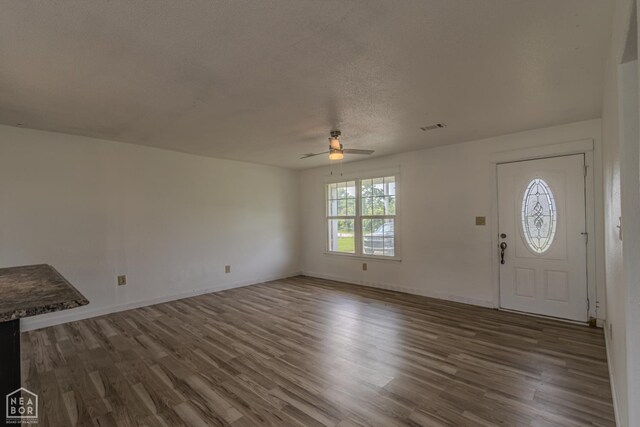 2303 E Lake St E, Paragould, AR 72450 - unfurnished room featuring wood finished floors, a ceiling fan, and baseboards
