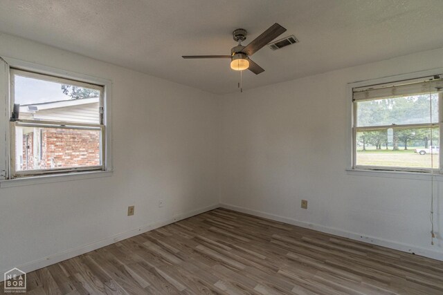 2303 E Lake St E, Paragould, AR 72450 - kitchen featuring a sink, light wood-style floors, decorative backsplash, dark cabinets, and pendant lighting
