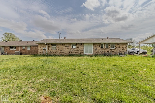 2303 E Lake St E, Paragould, AR 72450 - rear view of property featuring cooling unit, brick siding, and a yard