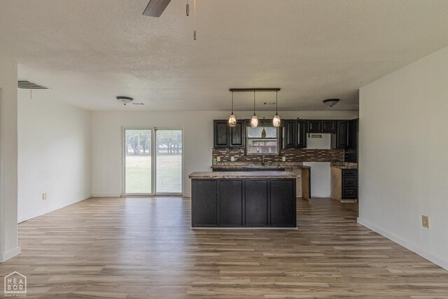 2303 E Lake St E, Paragould, AR 72450 - bathroom with a stall shower, crown molding, toilet, wood finished floors, and a sink