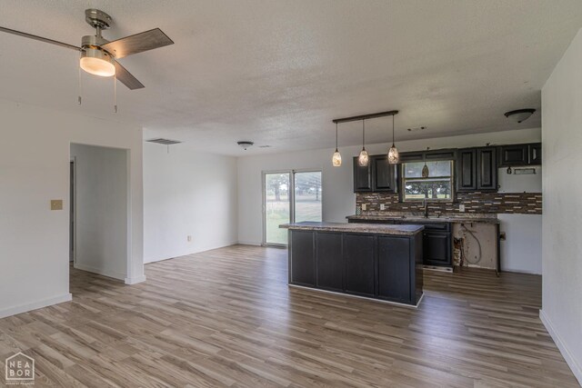 2303 E Lake St E, Paragould, AR 72450 - unfurnished bedroom with light wood-type flooring, baseboards, and a ceiling fan