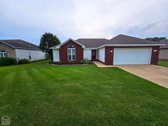 243 N Oak St, Brookland, AR 72417 - ranch-style home with a garage, a front yard, and driveway