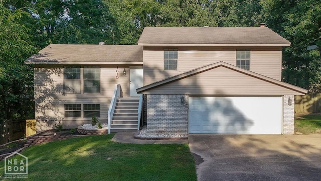 1610 Smoot Dr, Jonesboro, AR 72401 - tri-level home with concrete driveway, brick siding, and stairway