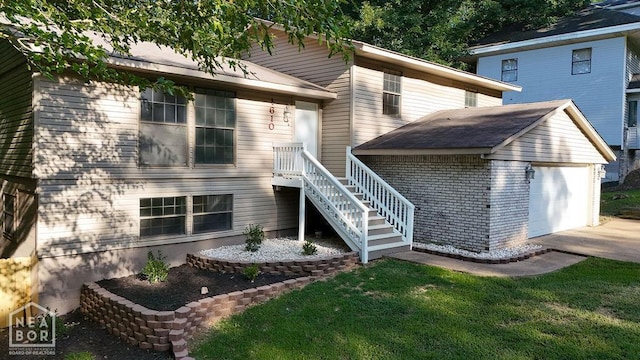 1610 Smoot Dr, Jonesboro, AR 72401 - back of property featuring concrete driveway, a lawn, and an attached garage