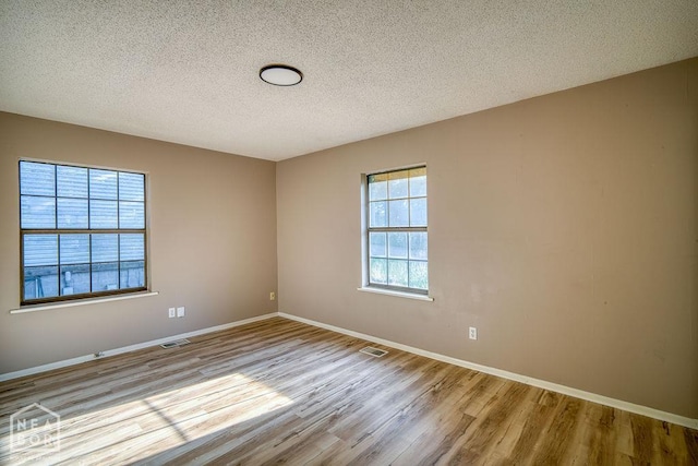1610 Smoot Dr, Jonesboro, AR 72401 - spare room with wood finished floors and a textured ceiling