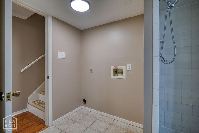 1610 Smoot Dr, Jonesboro, AR 72401 - laundry area with washer hookup, electric dryer hookup, and light tile patterned floors