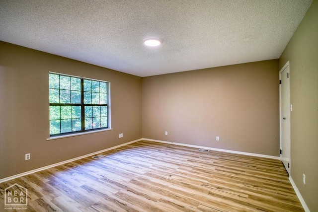 1610 Smoot Dr, Jonesboro, AR 72401 - unfurnished room with light wood-style floors and a textured ceiling