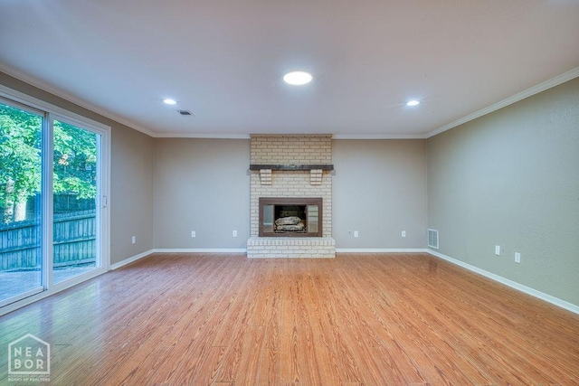 1610 Smoot Dr, Jonesboro, AR 72401 - unfurnished living room featuring crown molding, light wood-style floors, recessed lighting, and a fireplace