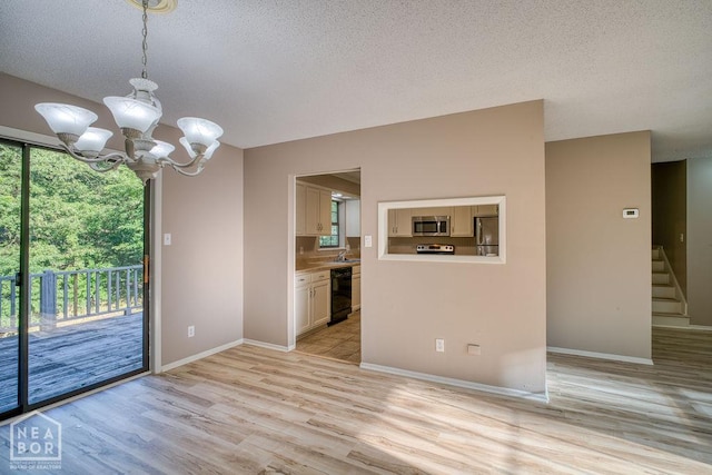 1610 Smoot Dr, Jonesboro, AR 72401 - unfurnished dining area with a chandelier, a textured ceiling, light wood-style floors, and stairs