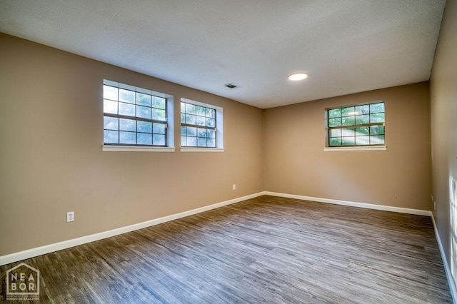 1610 Smoot Dr, Jonesboro, AR 72401 - unfurnished room with wood finished floors, plenty of natural light, and recessed lighting
