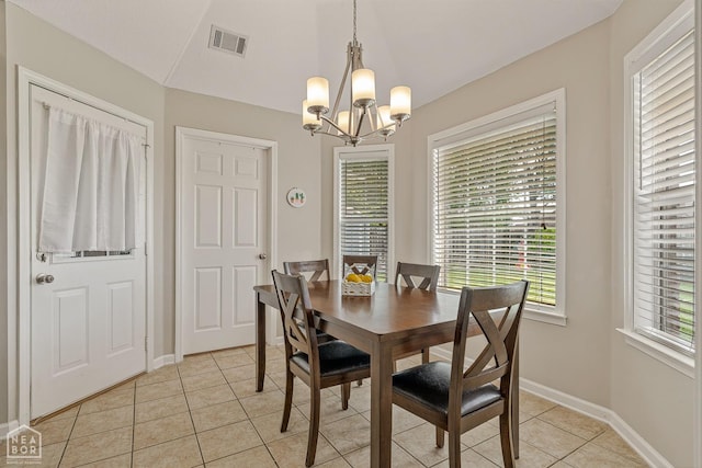 dining area featuring a chandelier, visible vents, light tile patterned floors, and baseboards