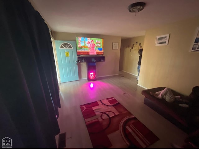 living room with baseboards and wood finished floors