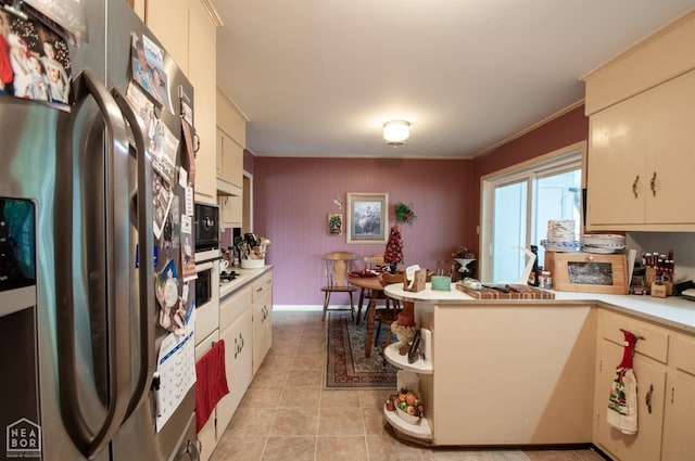 kitchen featuring freestanding refrigerator, light countertops, ornamental molding, a peninsula, and light tile patterned flooring