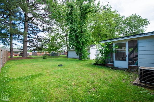 view of yard featuring central air condition unit and a sunroom