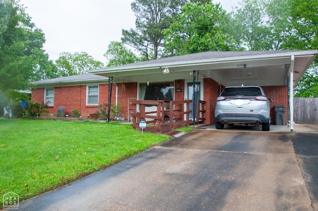 ranch-style house with brick siding, a front lawn, driveway, and a carport