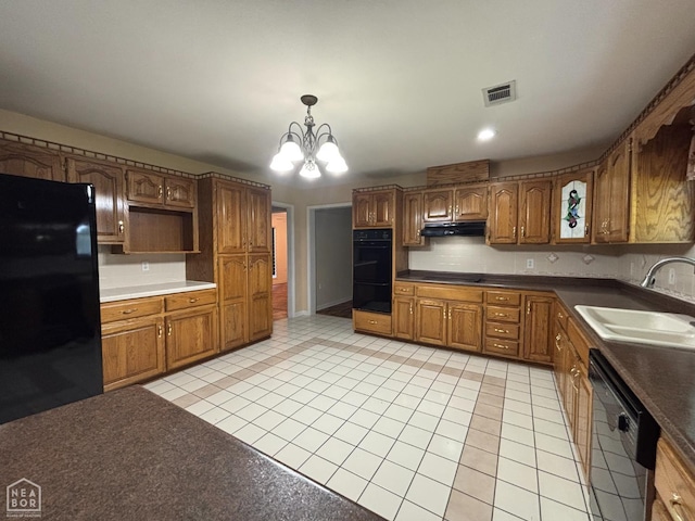100 Charleston Dr, Walnut Ridge, AR 72476 - kitchen featuring black appliances, light tile patterned floors, brown cabinets, and a chandelier