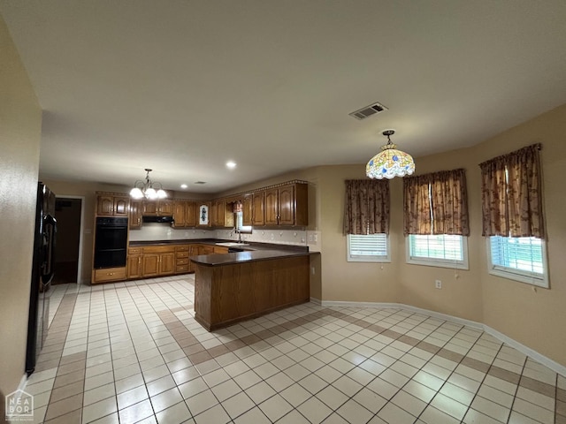 100 Charleston Dr, Walnut Ridge, AR 72476 - kitchen featuring a peninsula, a chandelier, dark countertops, light tile patterned flooring, and recessed lighting