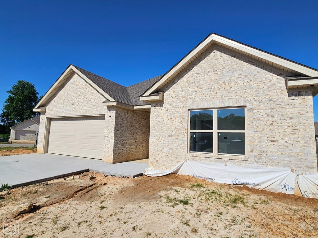 4561 Plymouth, Jonesboro, AR 72405 - single story home featuring concrete driveway, an attached garage, and stone siding