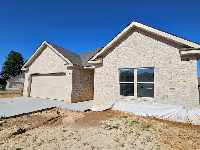 4561 Plymouth, Jonesboro, AR 72405 - single story home featuring concrete driveway, an attached garage, and stone siding