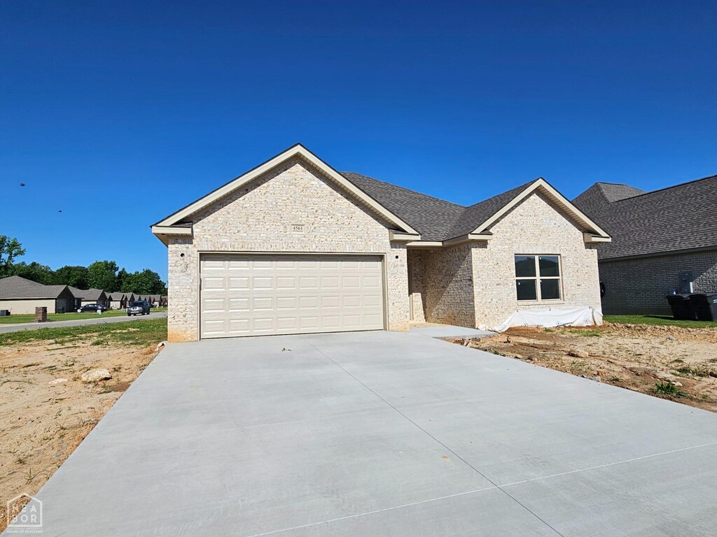 4561 Plymouth, Jonesboro, AR 72405 - view of front of property with a garage, brick siding, and driveway