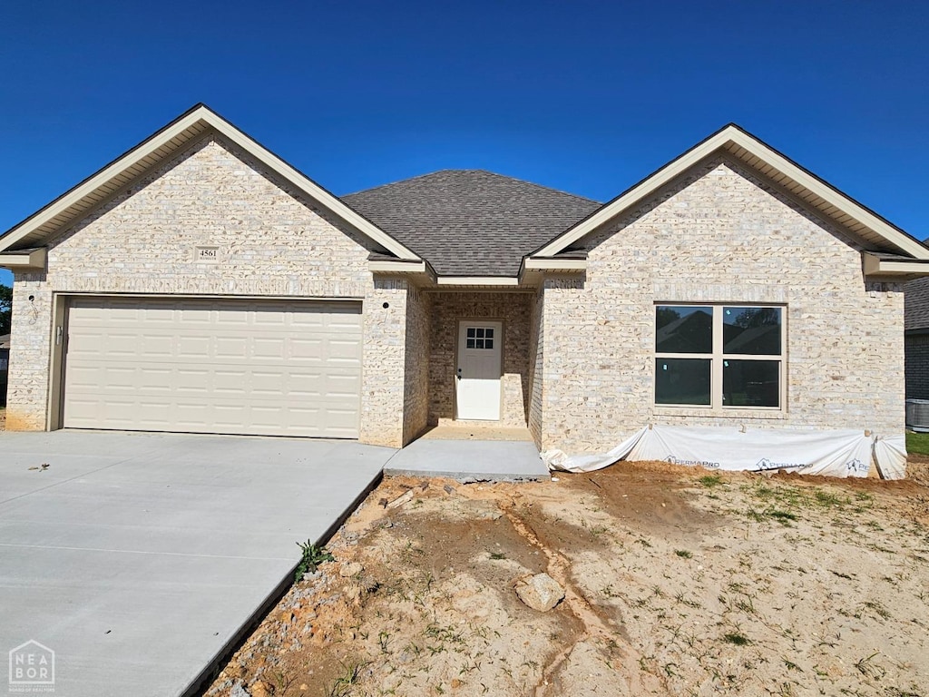 4561 Plymouth, Jonesboro, AR 72405 - ranch-style home featuring concrete driveway, an attached garage, and a shingled roof