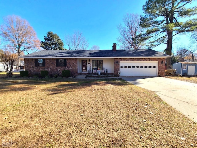 single story home with a chimney, brick siding, an attached garage, concrete driveway, and a front yard