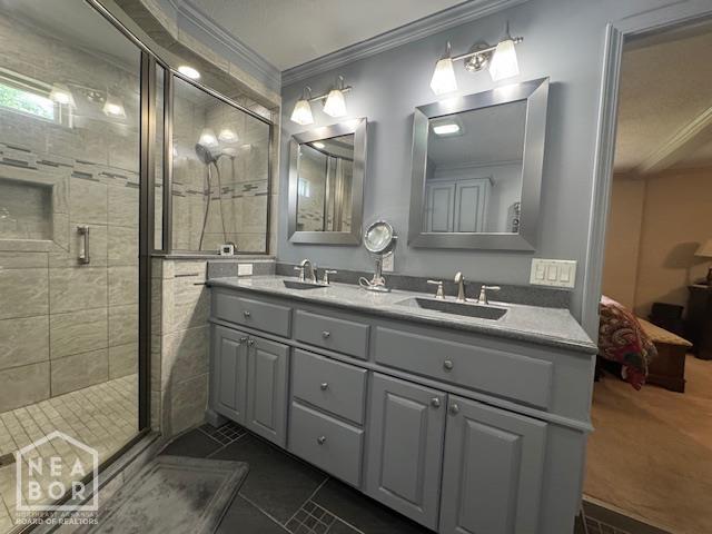 700 11th St, Corning, AR 72422 - full bath featuring ornamental molding, double vanity, a stall shower, tile patterned flooring, and ensuite bath