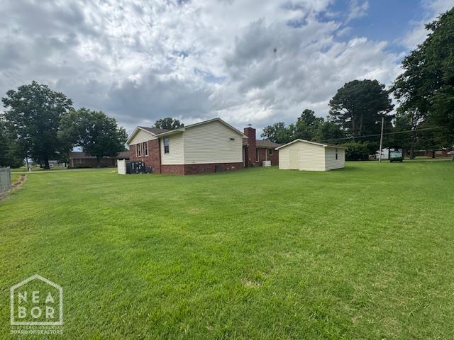 700 11th St, Corning, AR 72422 - view of green lawn with an outbuilding