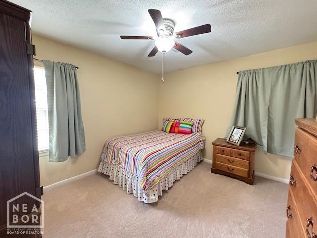 700 11th St, Corning, AR 72422 - bedroom with light colored carpet, a textured ceiling, and ceiling fan