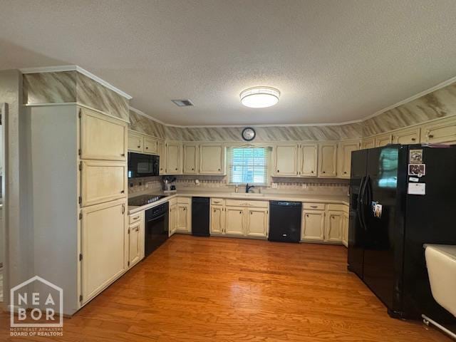 700 11th St, Corning, AR 72422 - kitchen featuring black appliances, light countertops, light wood-style flooring, a textured ceiling, and tasteful backsplash