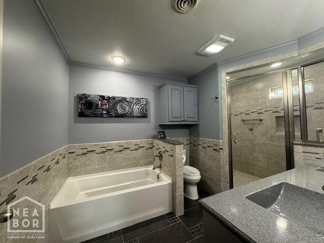 700 11th St, Corning, AR 72422 - bathroom featuring tile walls, ornamental molding, vanity, a garden tub, and a shower stall
