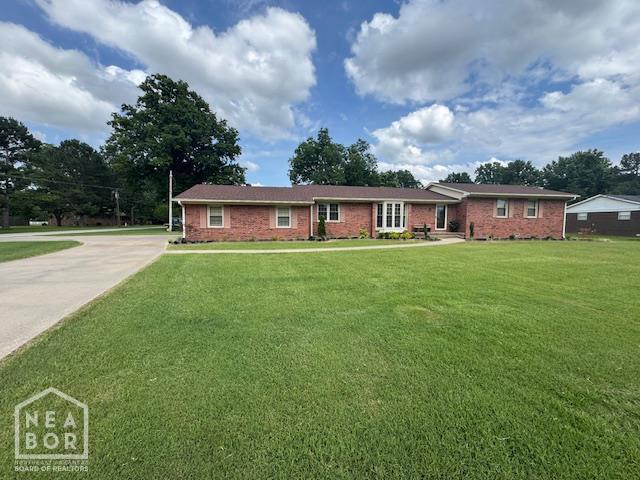 700 11th St, Corning, AR 72422 - single story home with a front lawn, concrete driveway, and brick siding