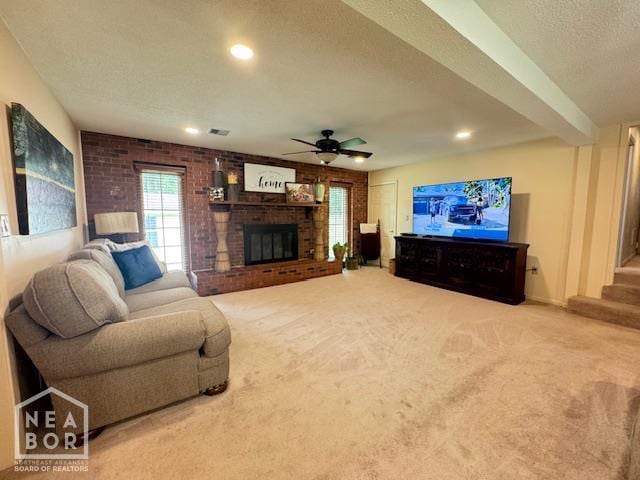 700 11th St, Corning, AR 72422 - carpeted living room with a textured ceiling, a brick fireplace, recessed lighting, and a ceiling fan