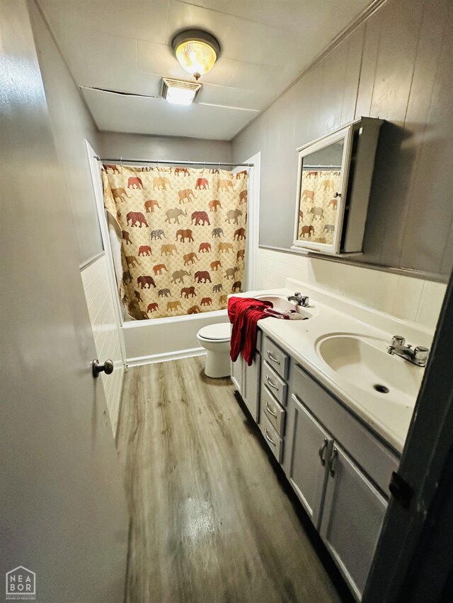 509 NE 4thw, Walnut Ridge, AR 72476 - bathroom with double vanity, wood finished floors, shower / bath combo, and wainscoting