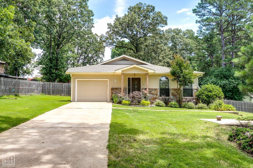 3910 Forest Hill Rd, Jonesboro, AR 72404 - view of front facade with stone siding, concrete driveway, an attached garage, and stucco siding
