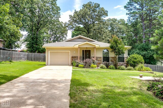 3910 Forest Hill Rd, Jonesboro, AR 72404 - view of front facade with stone siding, concrete driveway, an attached garage, and stucco siding