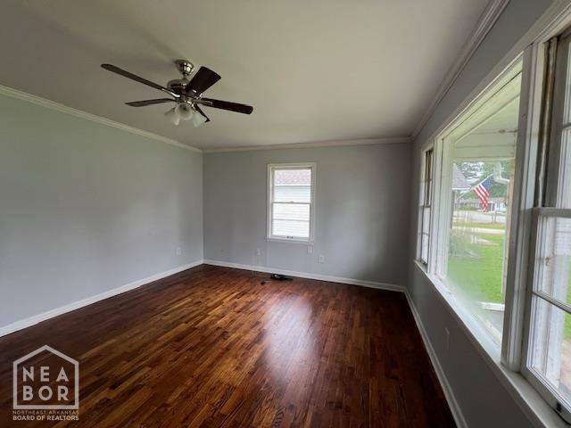 304 S 11th Ave S, Paragould, AR 72450 - spare room featuring dark wood-style flooring, crown molding, and ceiling fan