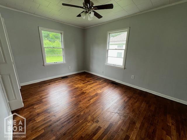 304 S 11th Ave S, Paragould, AR 72450 - empty room with ornamental molding, healthy amount of natural light, wood finished floors, and ceiling fan