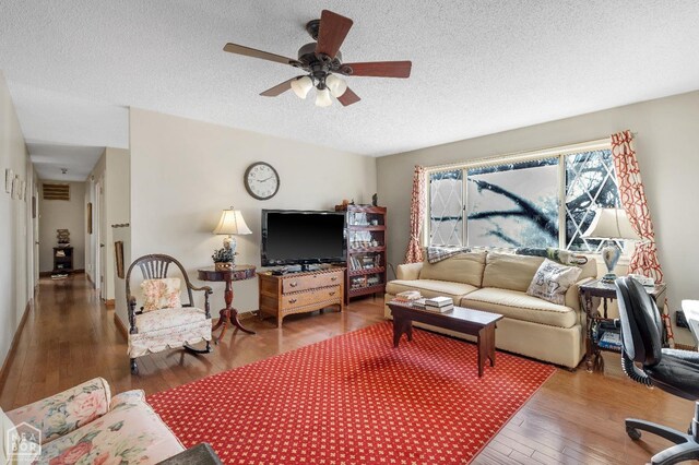 154 Mockingbird Cir, Marmaduke, AR 72443 - living area with hardwood / wood-style floors, ceiling fan, visible vents, and a textured ceiling
