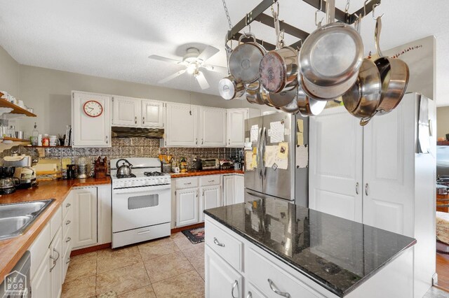 154 Mockingbird Cir, Marmaduke, AR 72443 - kitchen featuring white gas range oven, freestanding refrigerator, backsplash, under cabinet range hood, and dishwasher