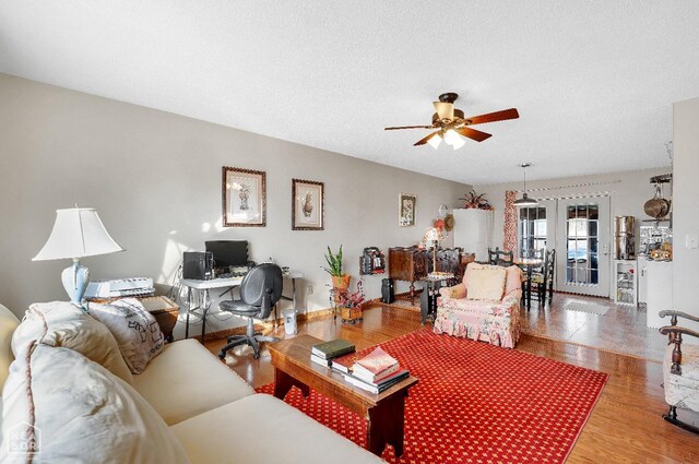 154 Mockingbird Cir, Marmaduke, AR 72443 - living room featuring a textured ceiling, a ceiling fan, and wood finished floors