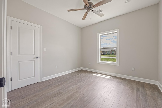 244 Quincy Cir, Trumann, AR 72472 - unfurnished room with baseboards, visible vents, wood finished floors, and ceiling fan