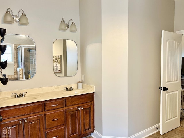 bathroom with double vanity, a sink, and a stall shower