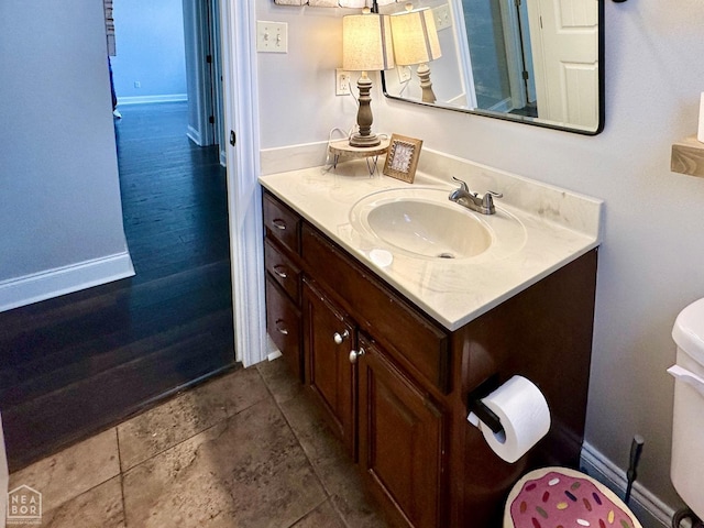 bathroom with vanity and baseboards