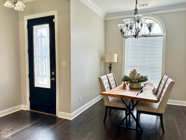 dining room featuring baseboards, visible vents, and a chandelier