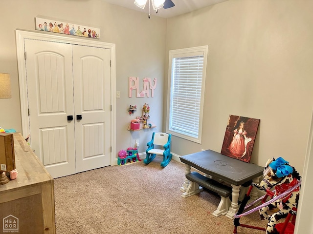 playroom featuring a ceiling fan and carpet