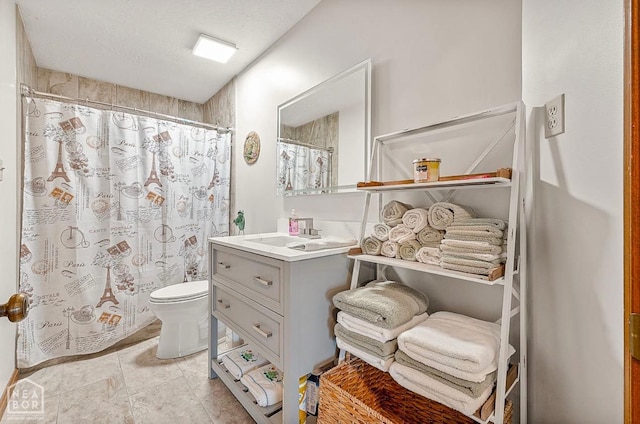 bathroom with vanity, a shower with shower curtain, and toilet