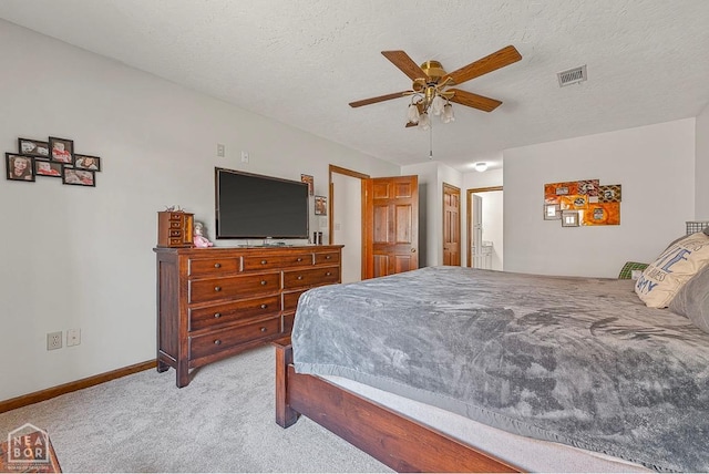 700 Oak Hollow Ln, Jonesboro, AR 72401 - bedroom with light carpet, baseboards, ensuite bath, a ceiling fan, and a textured ceiling