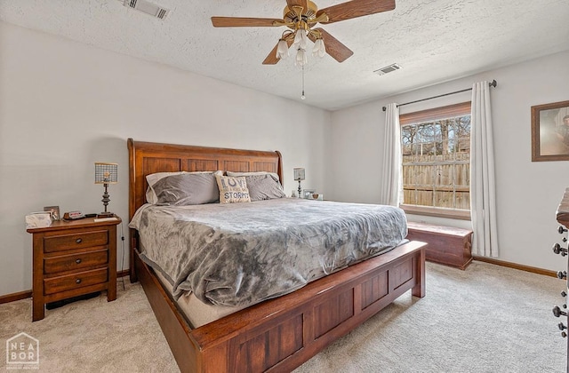 700 Oak Hollow Ln, Jonesboro, AR 72401 - bedroom with light colored carpet, a textured ceiling, baseboards, and a ceiling fan