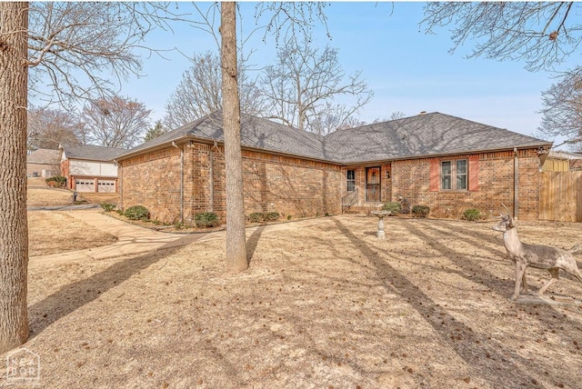 700 Oak Hollow Ln, Jonesboro, AR 72401 - rear view of property featuring brick siding and a shingled roof